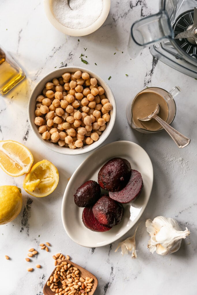 5-Minute Blender Beet Hummus - chickpeas, beets, lemons and tahini on countertop