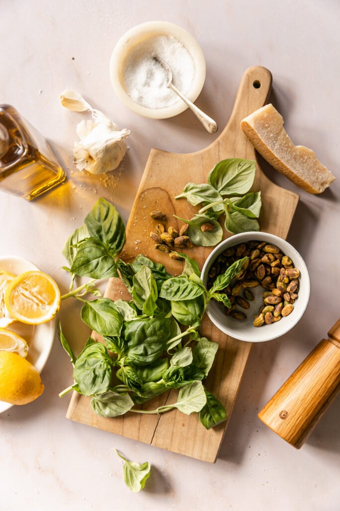 basil, pistachios, lemons on cutting board