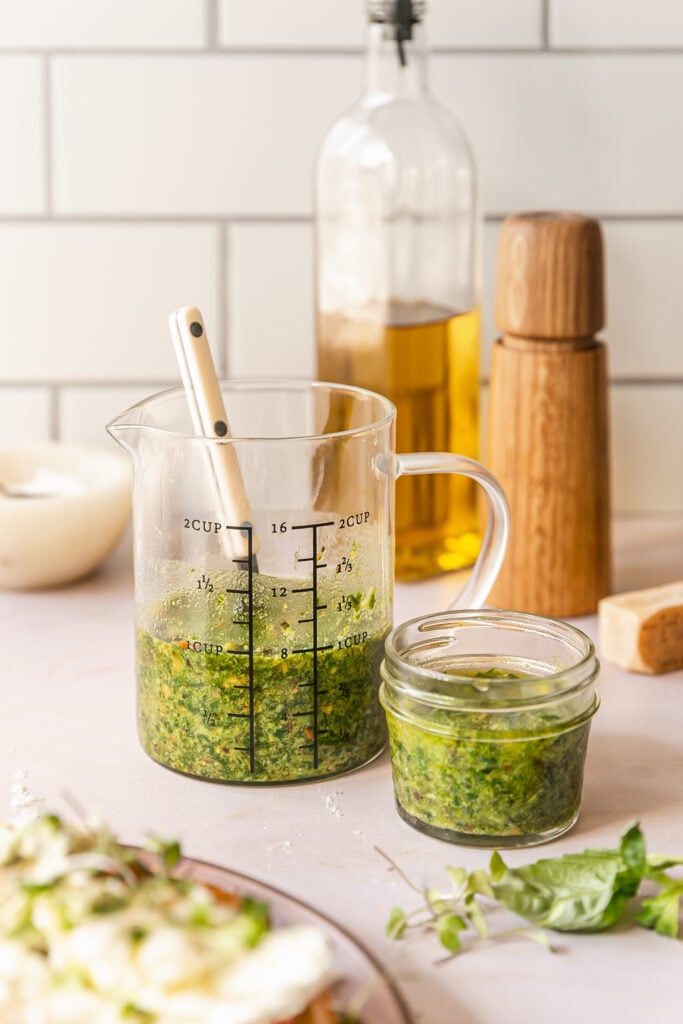 pesto in jar and pitcher on countertop