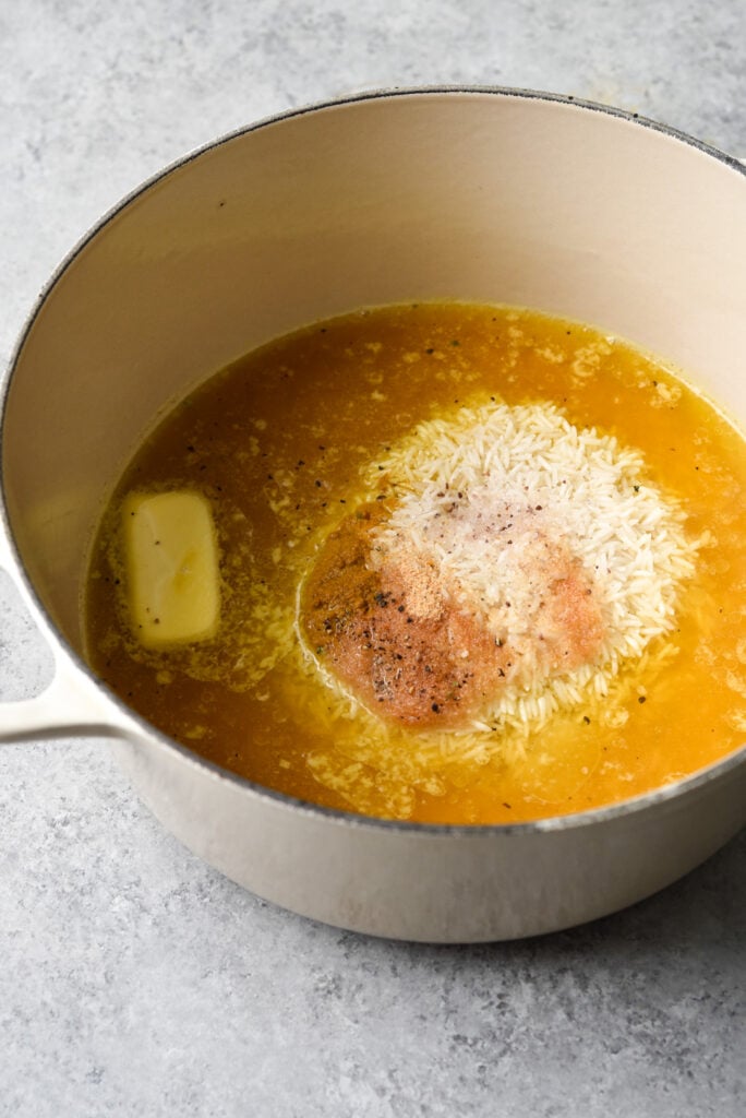 overhead shot of pot with rice, butter and spices