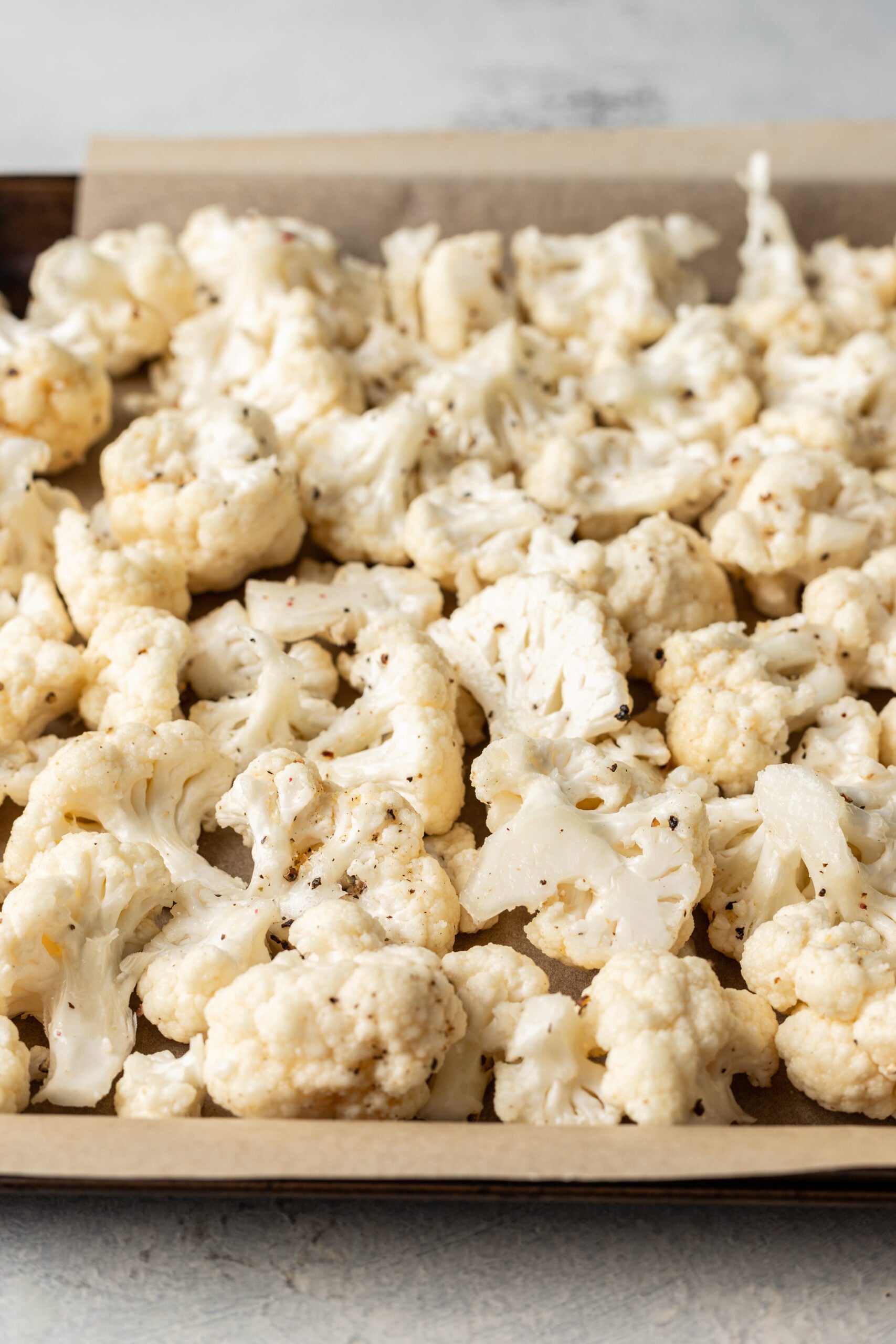 close up shot of raw cauliflower on a sheet pan