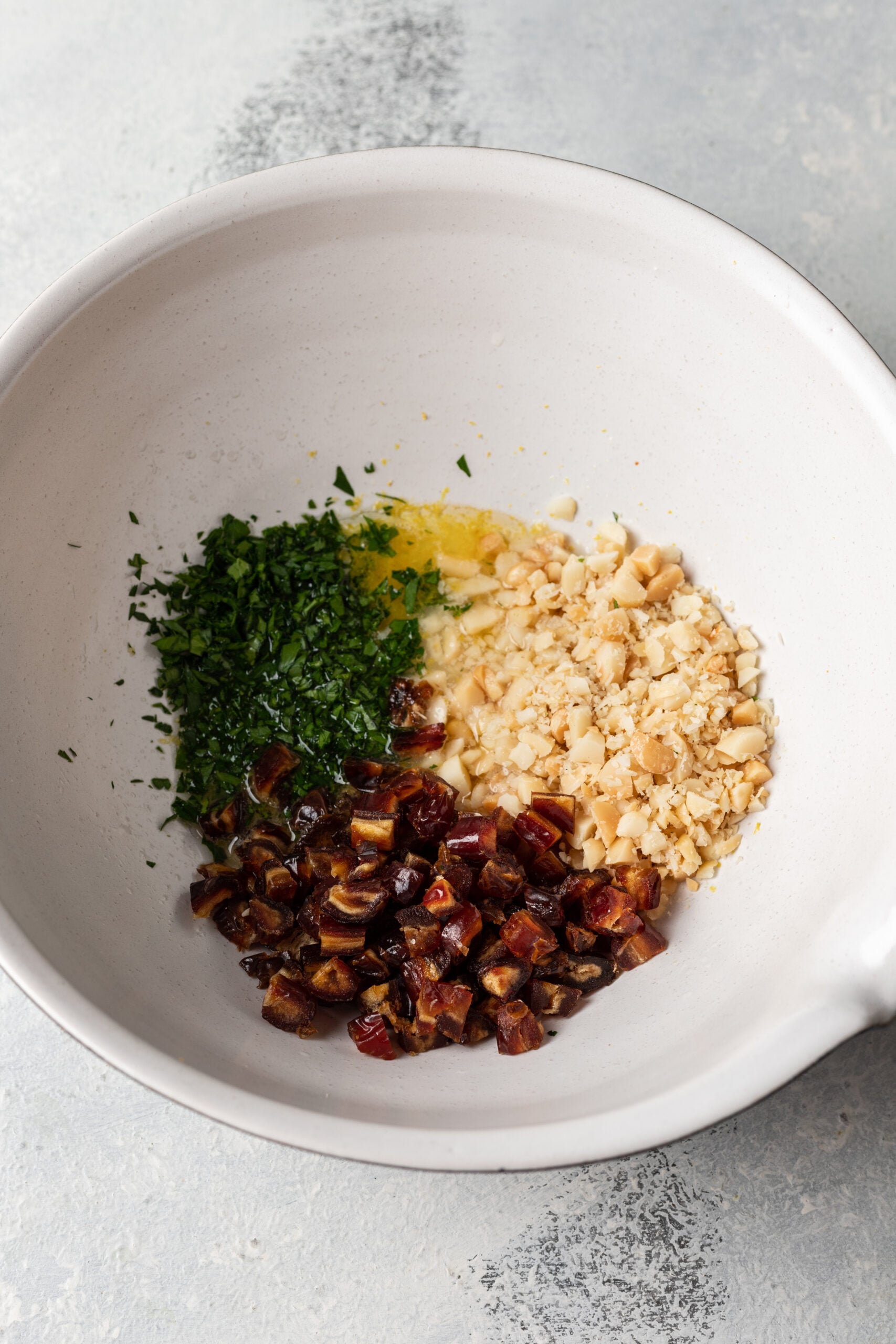 chopped dates, nuts and parsley in a bowl