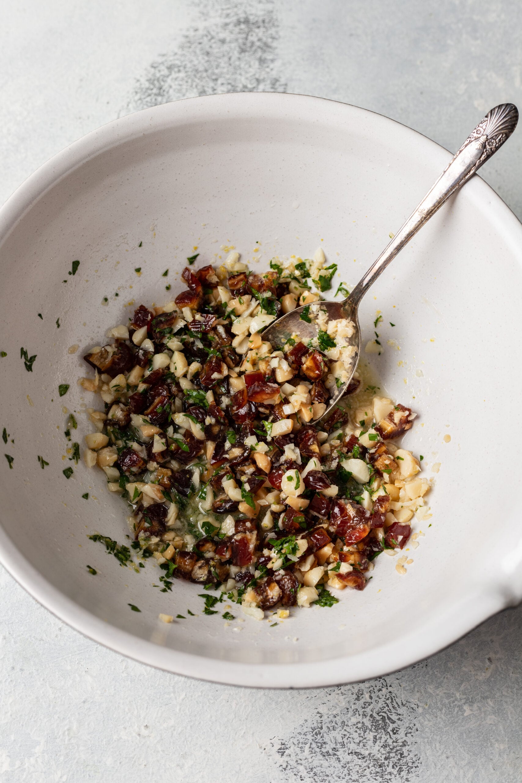 chopped dates, nuts and parsley in a bowl