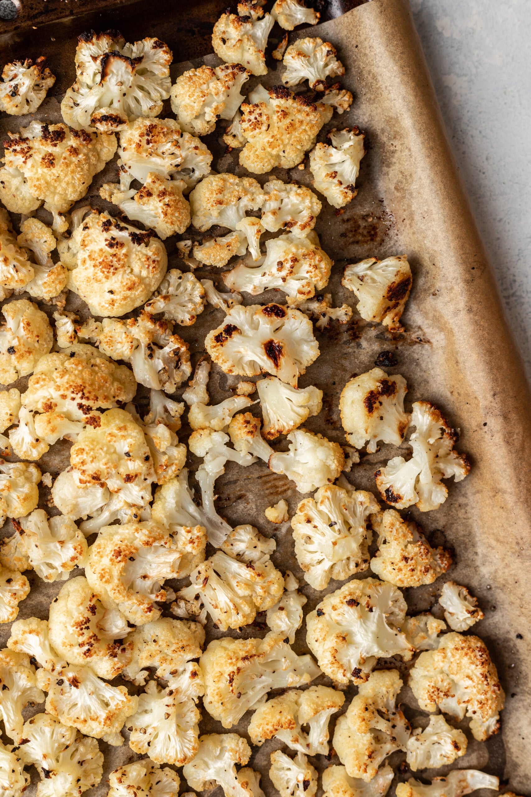 close up shot of cooked cauliflower on a sheet pan