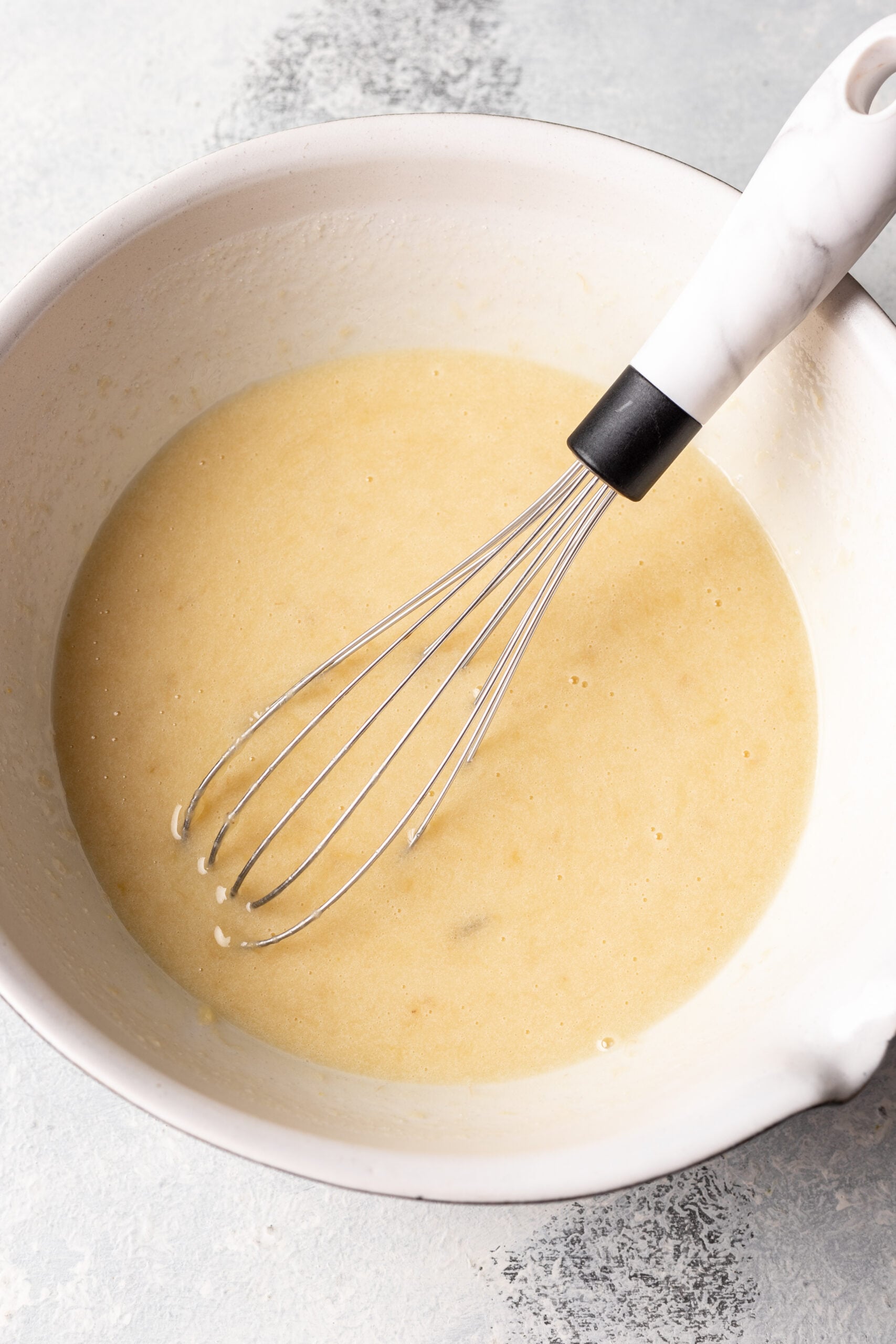 eggs, sugar, mashed banana, milk and vanilla whisked in a bowl