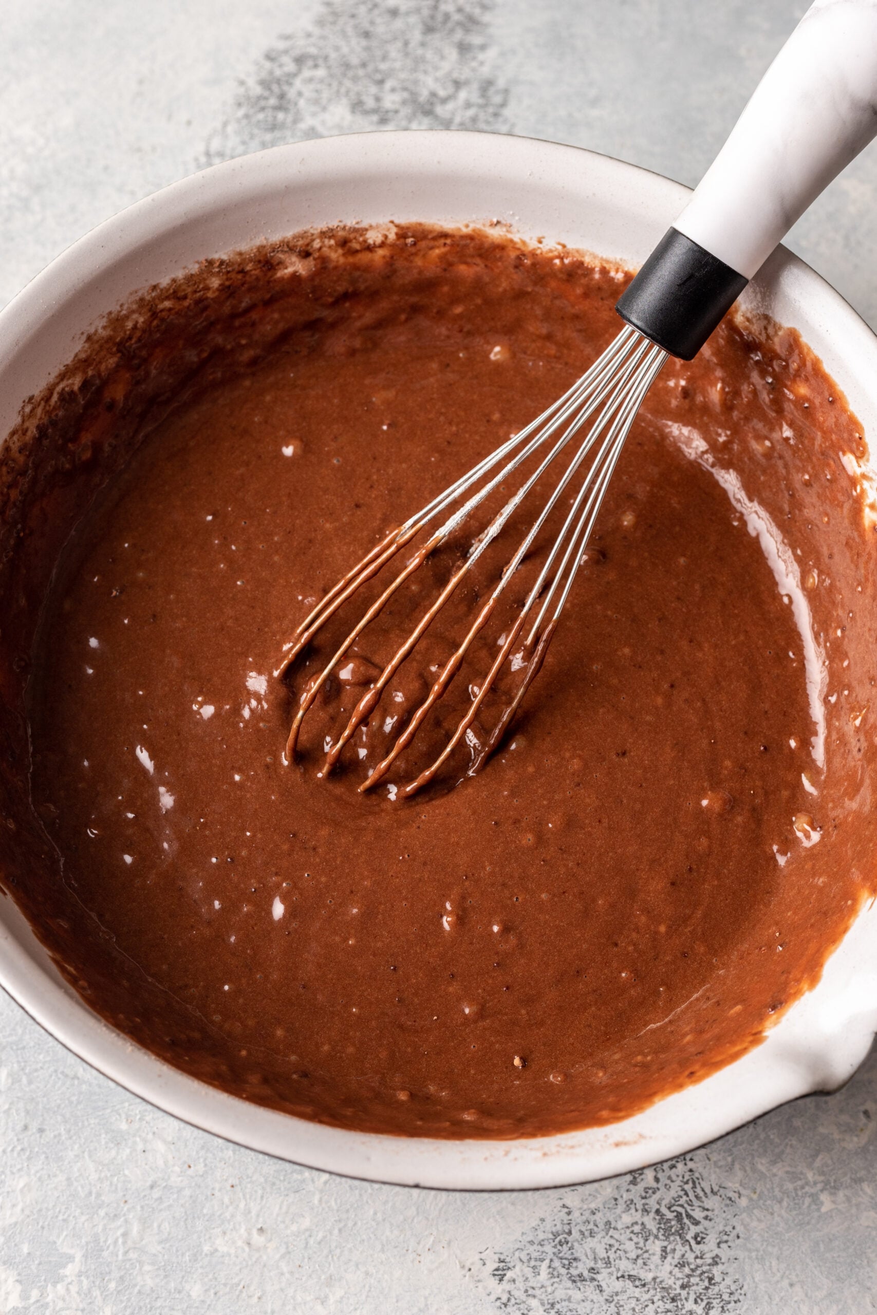 chocolate batter in a bowl with a whisk