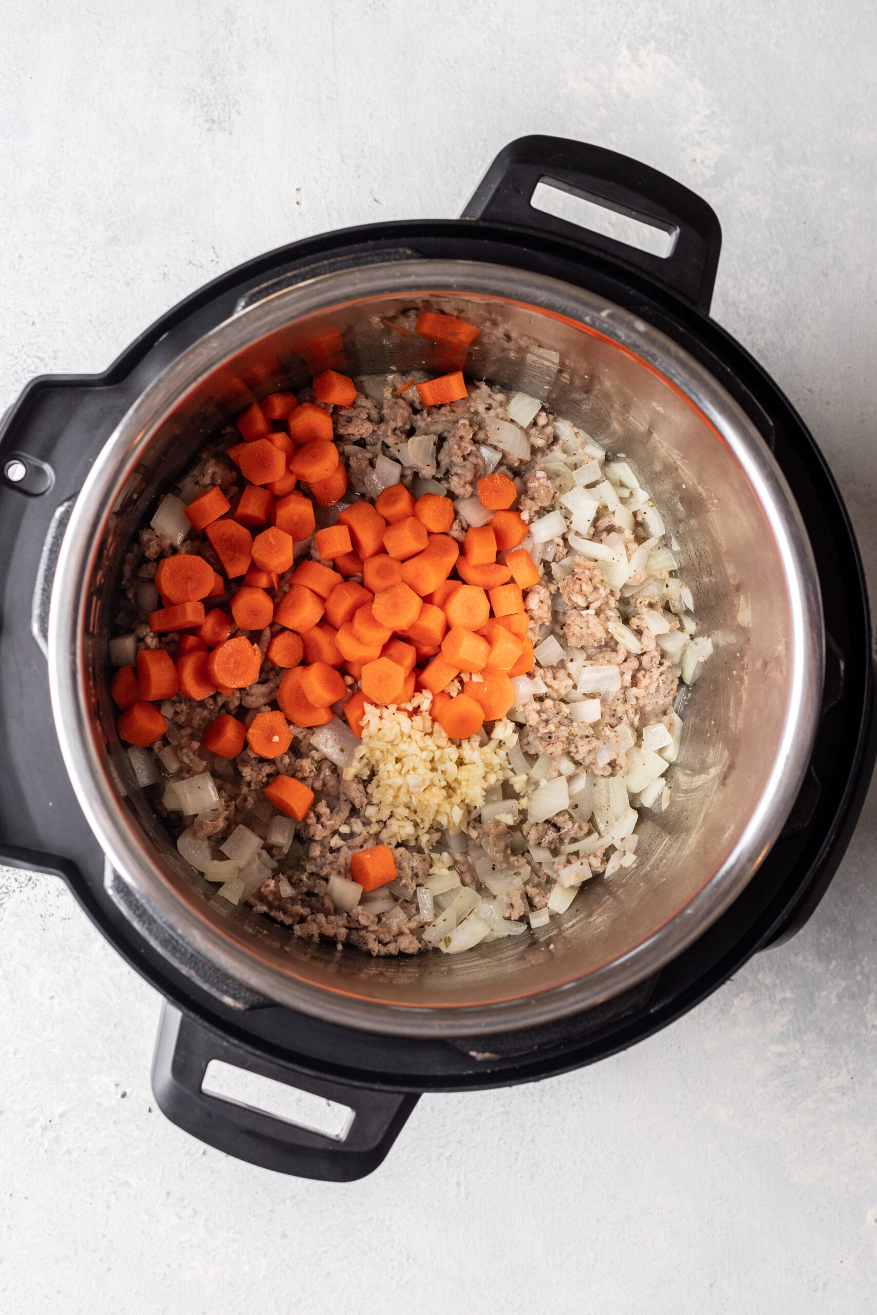 instant pot with onions and cooked ground turkey and carrots