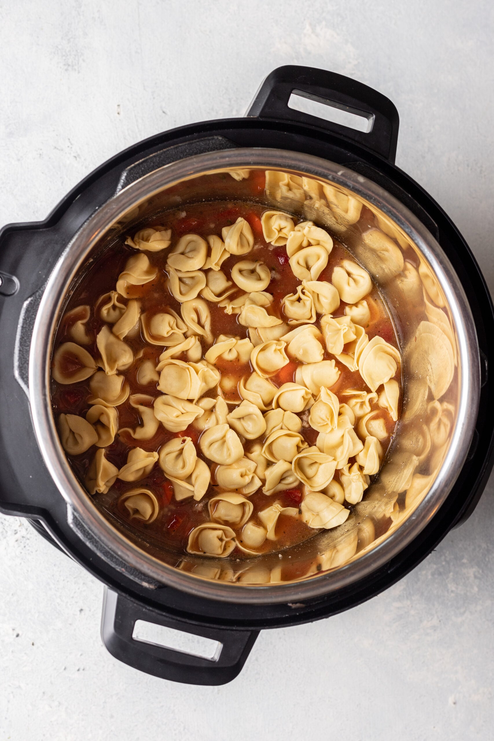 instant pot with tomato sauce and tortellinis