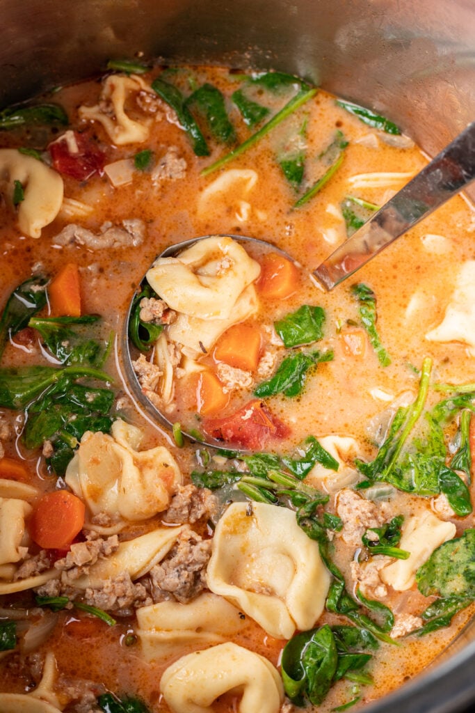 tortellini soup in an instant pot with a ladle