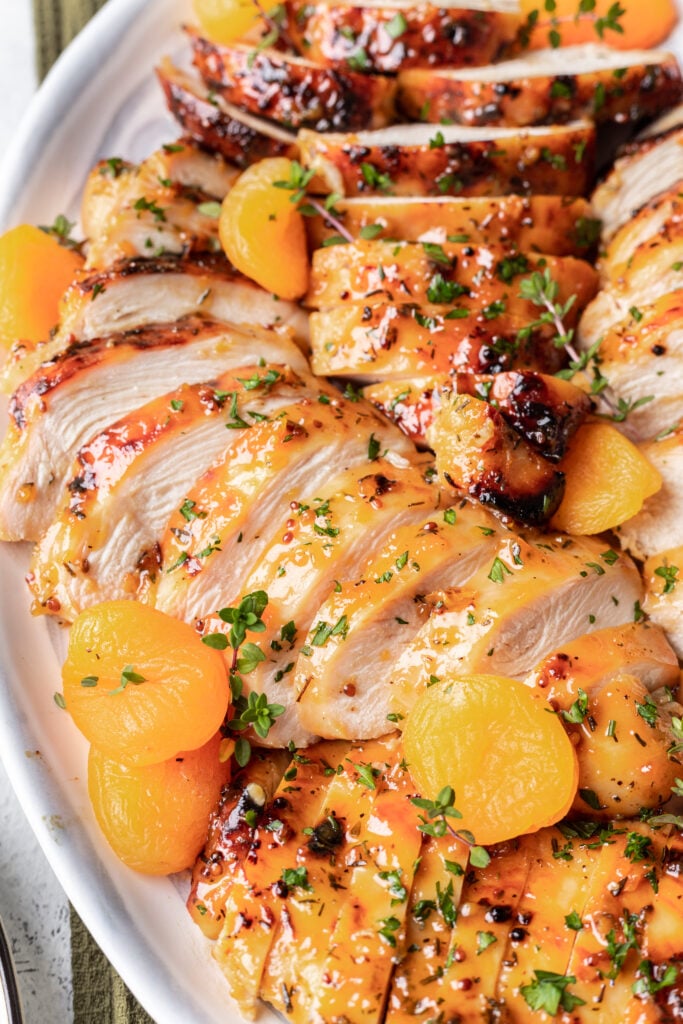 sliced chicken with apricots on a platter