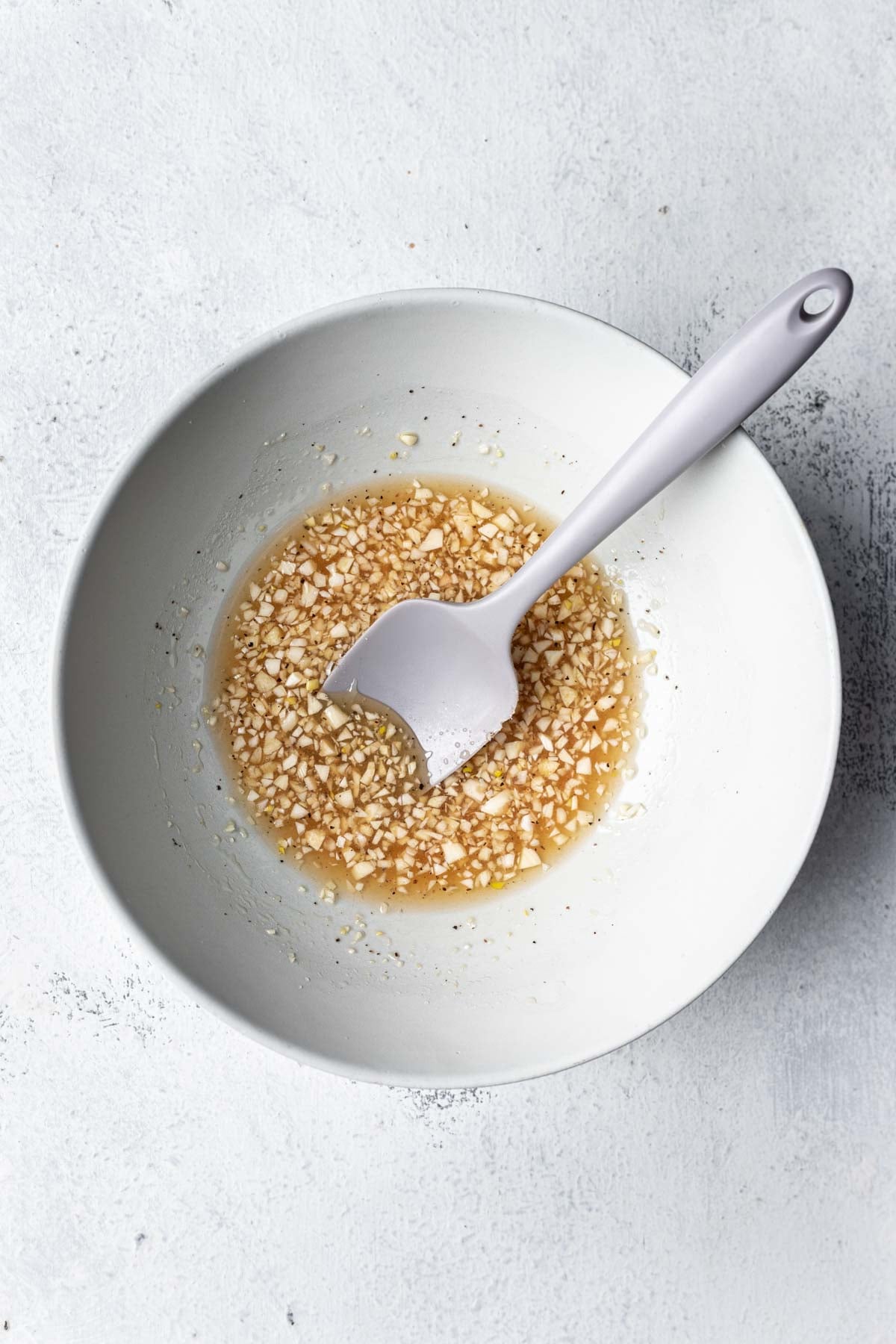 a bowl with sauce and garlic
