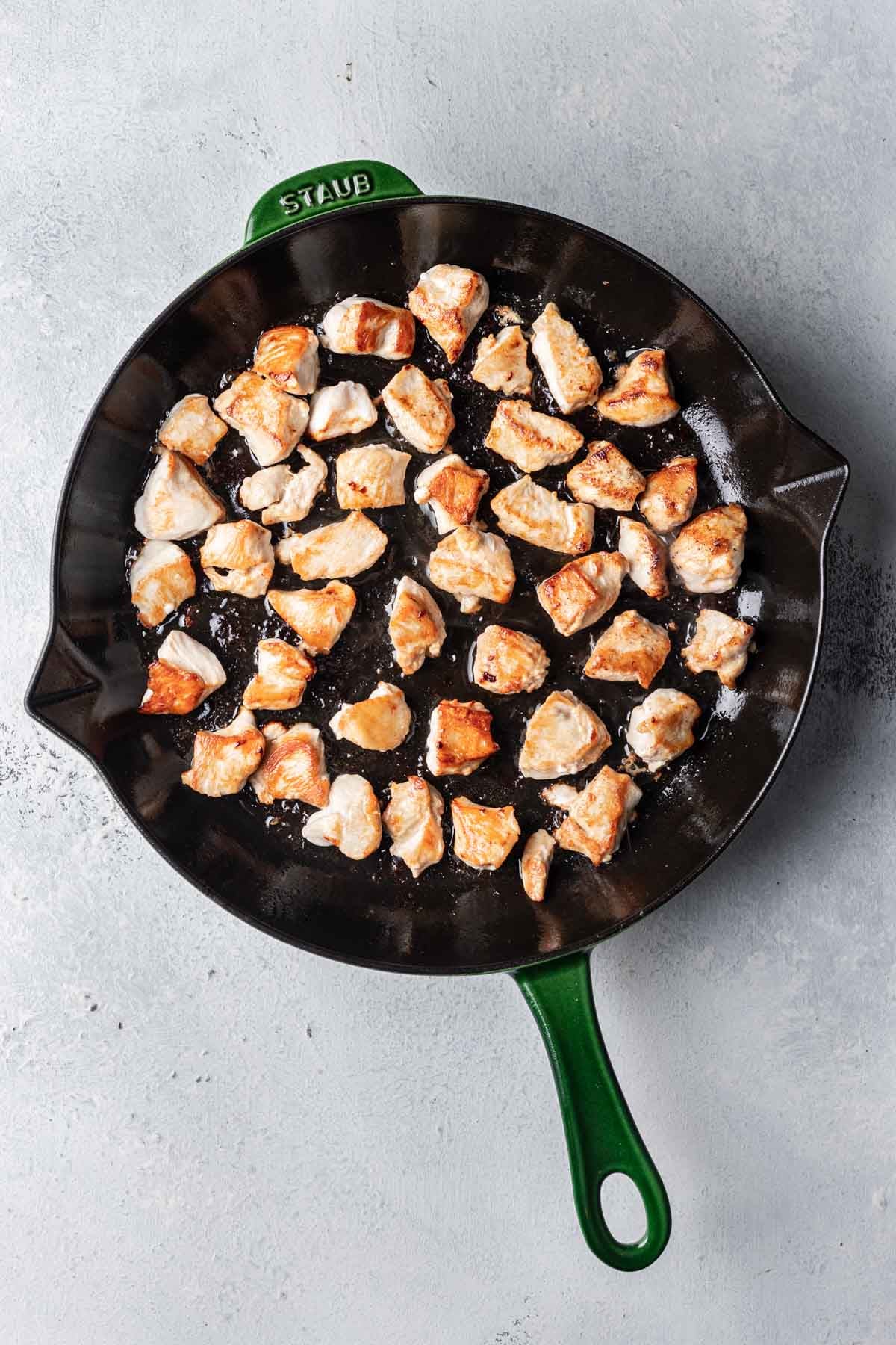 browned chicken pieces in a pan