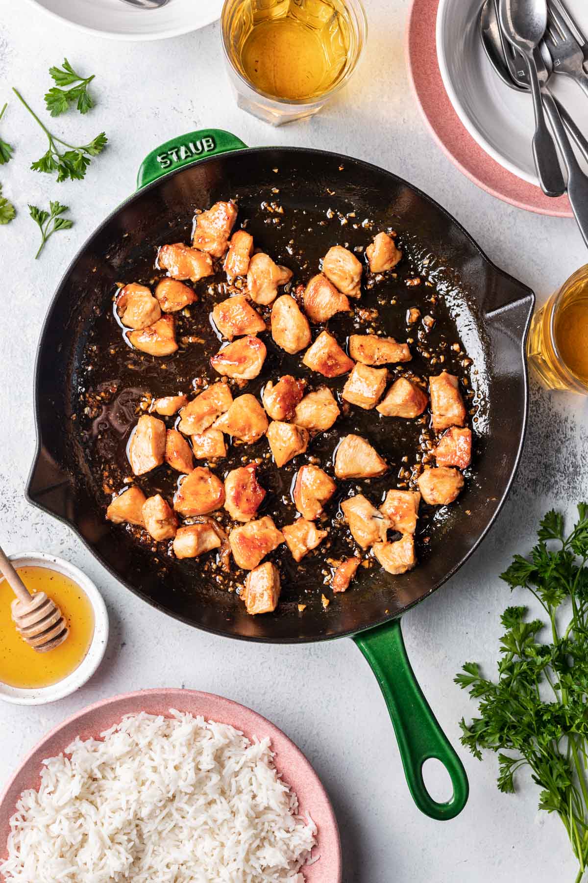 chicken pieces coated in sauce in a pan