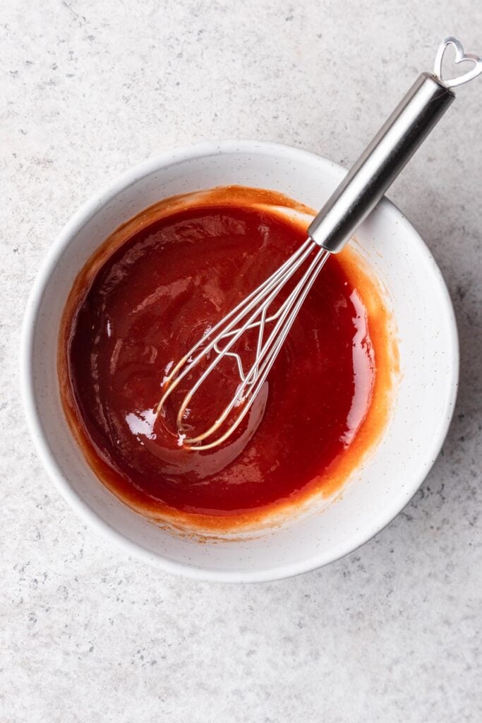 glaze in a bowl with a whisk