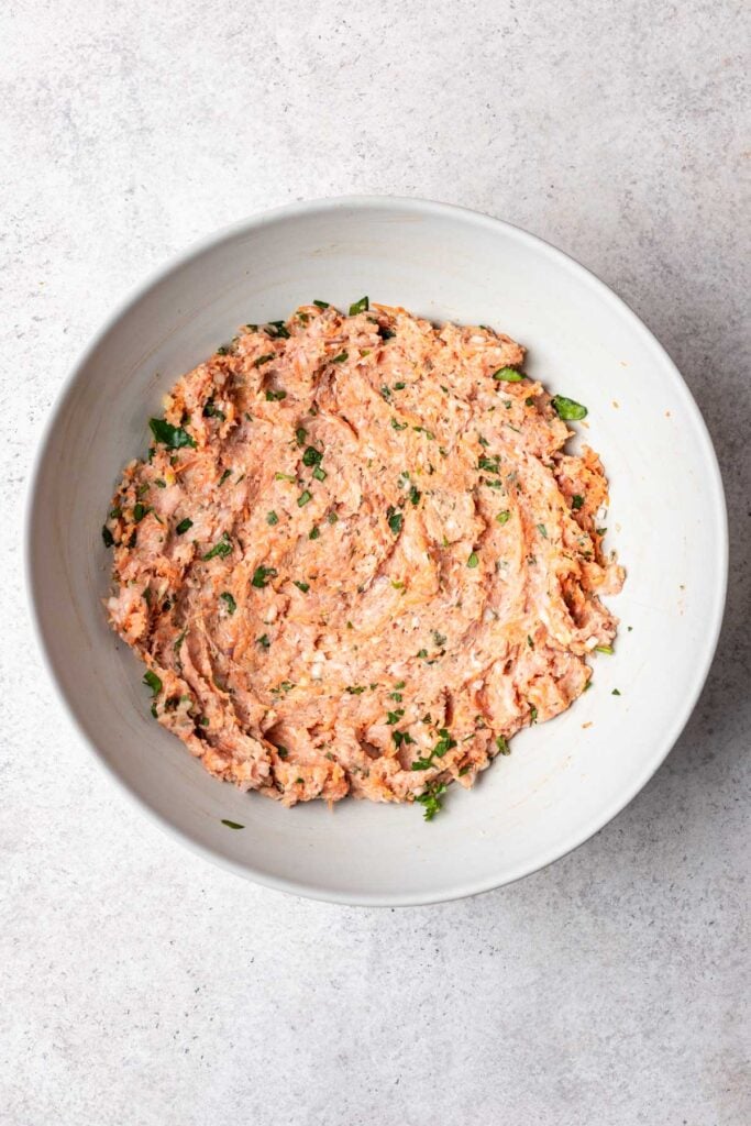ingredients mixed in a bowl for meatloaf meatballs