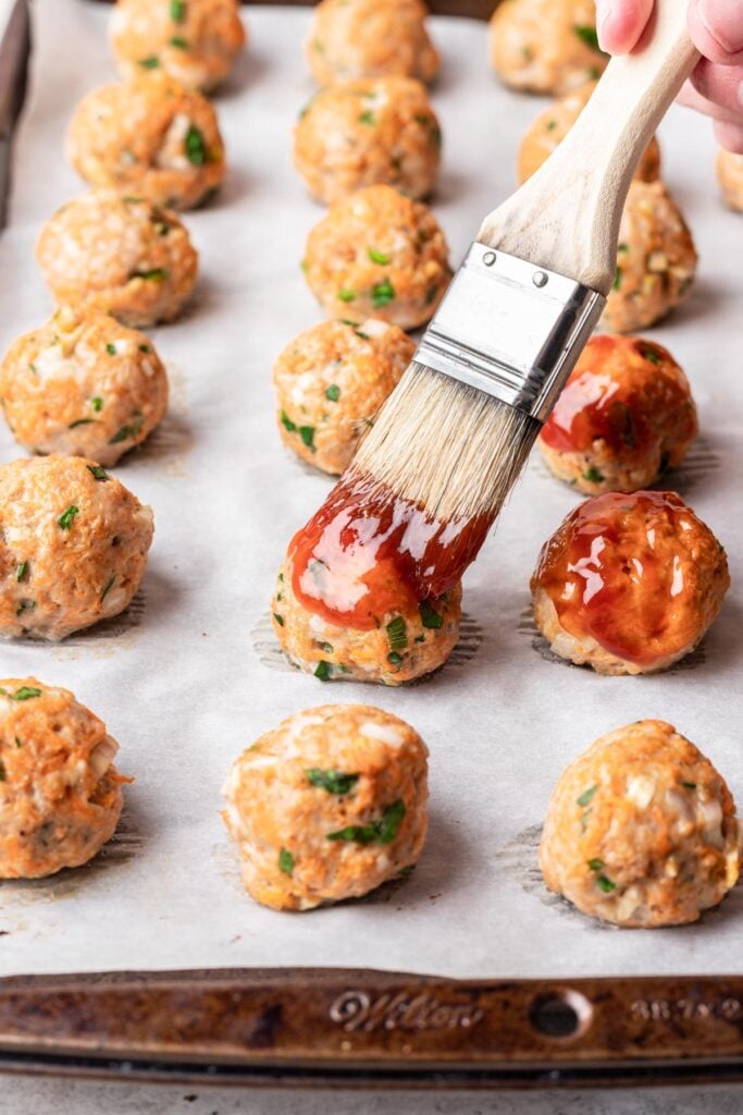 brushing glaze on meatballs