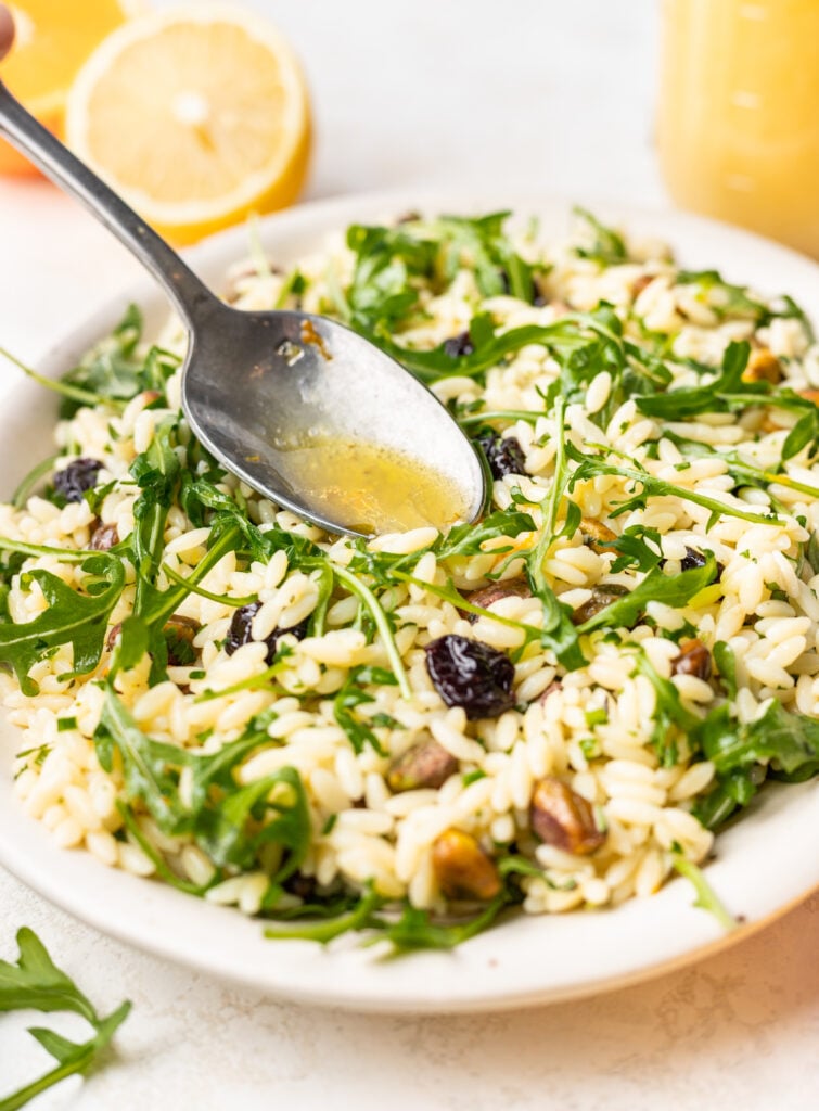 citrus dressing drizzled on top of orzo pasta