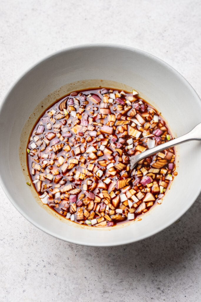 marinade ingredients in a bowl with a spoon