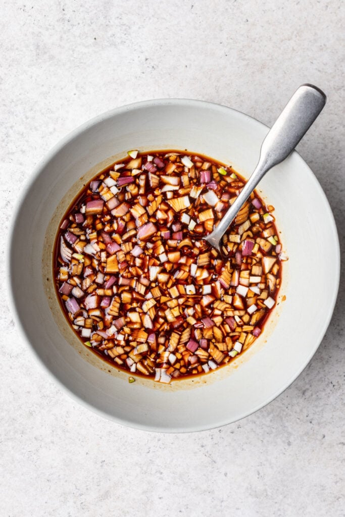 marinade ingredients in a bowl with a spoon