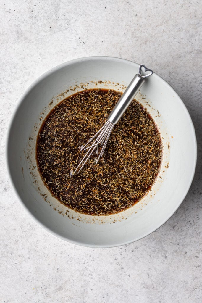balsamic marinade in a bowl with a whisk