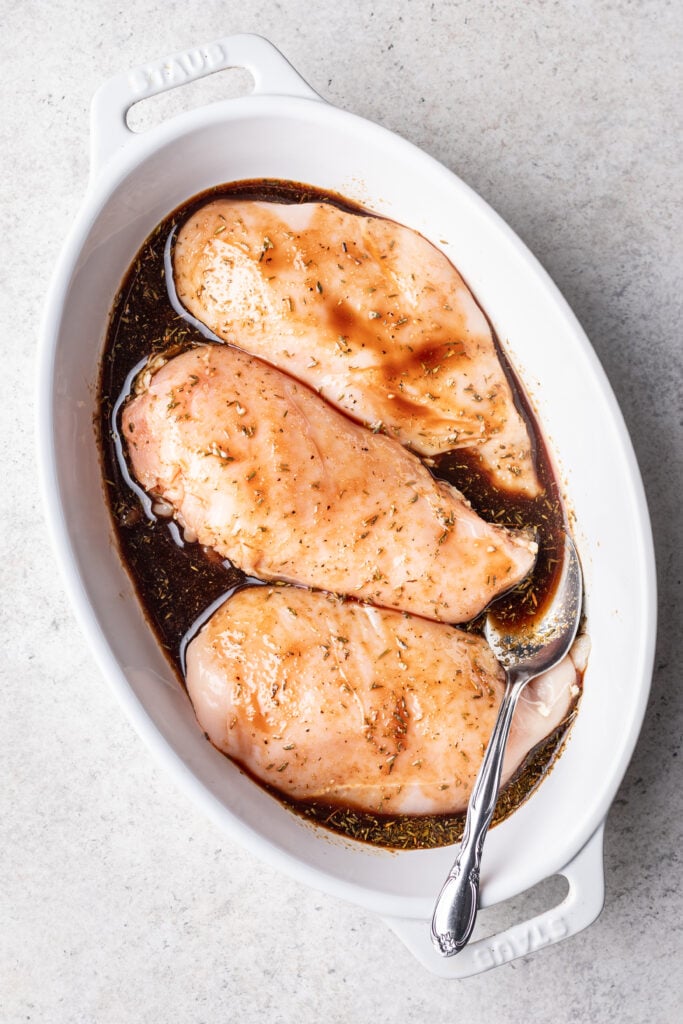 raw chicken in a dish with balsamic marinade