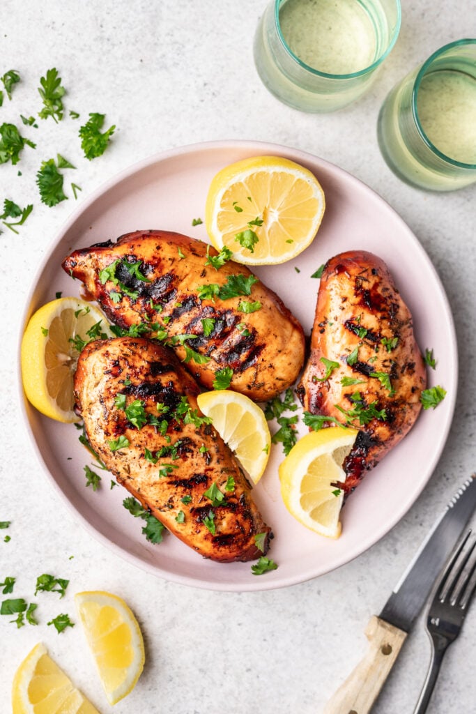 grilled chicken on a pink plate