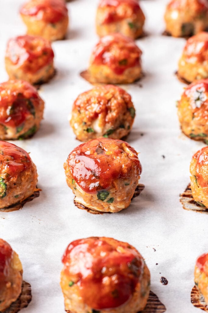 meatballs on a parchment lined baking sheet