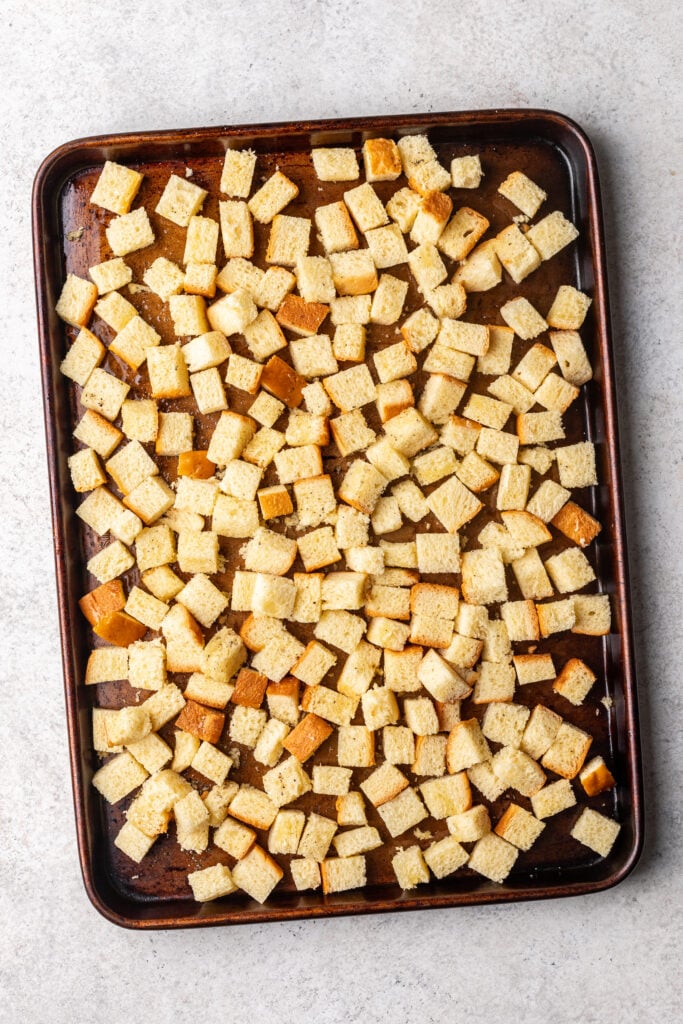 diced brioche bread on a sheet pan
