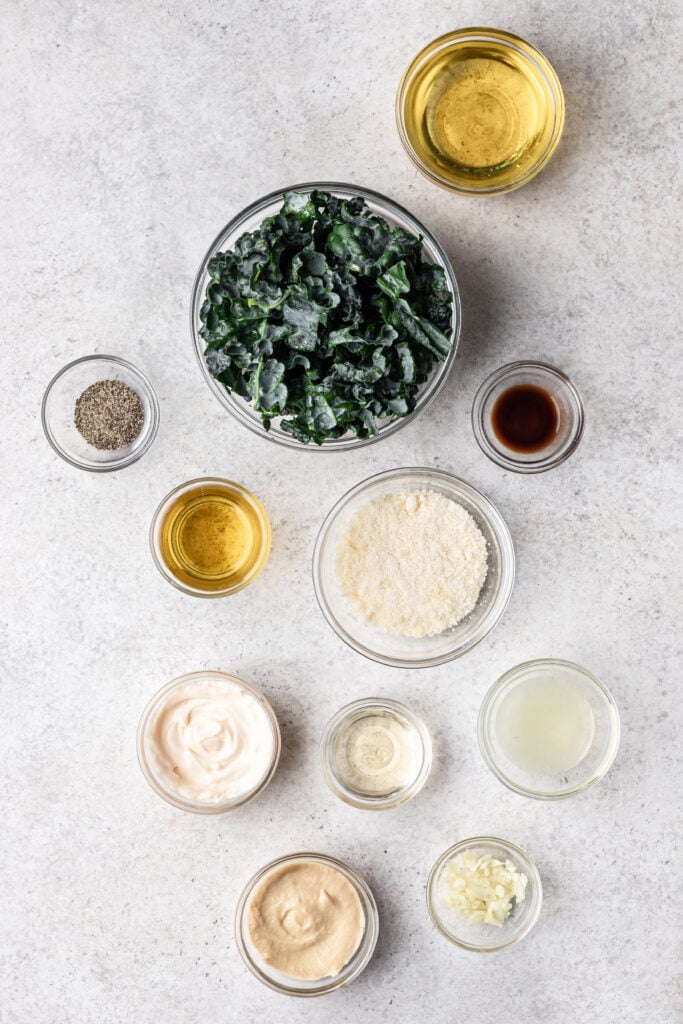 bowls of foods like chopped kale, olive oil, parmesan and lemon juice