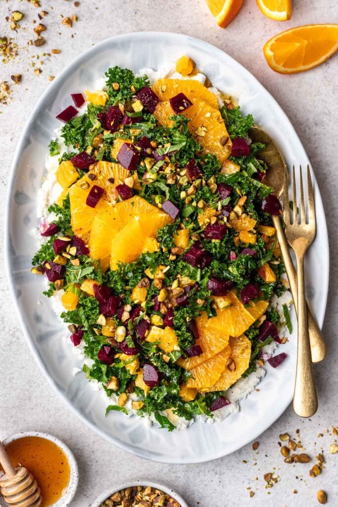 kale salad with oranges and beets on a platter