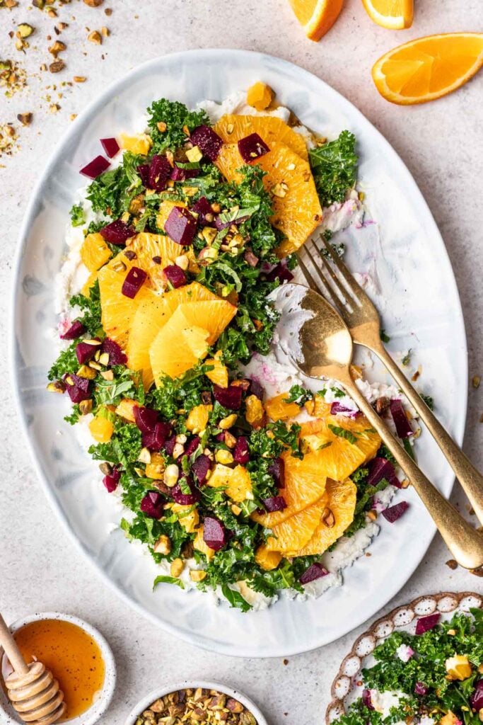 kale salad with oranges and beets on a platter
