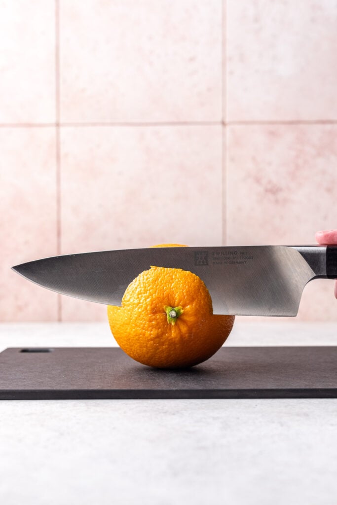 knife peeling an orange