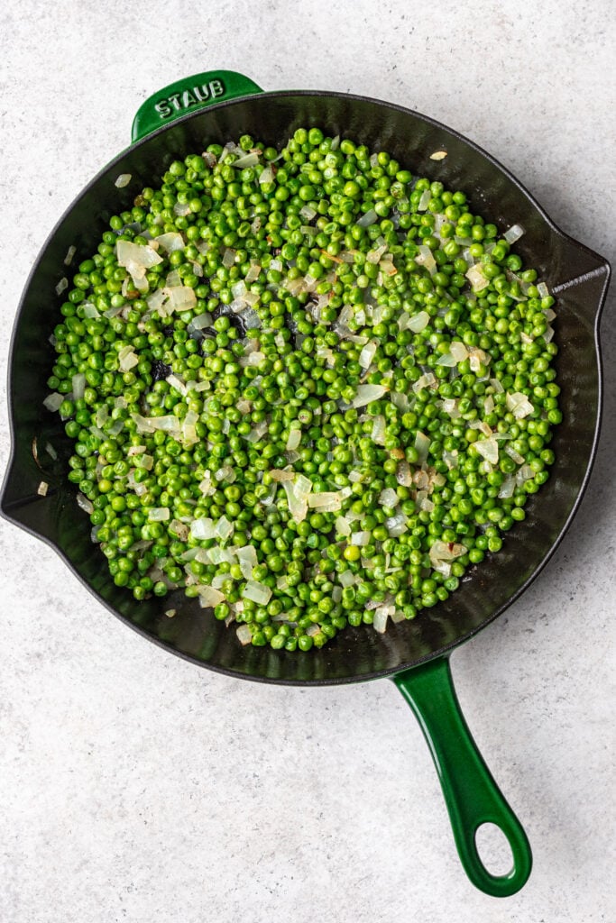 skillet with peas and onions