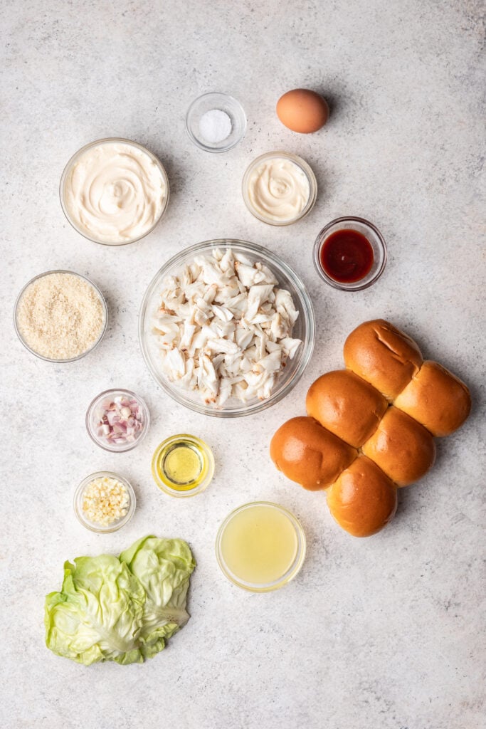 ingredients in bowls such as fresh crab, slider buns, mayonnaise and shallot