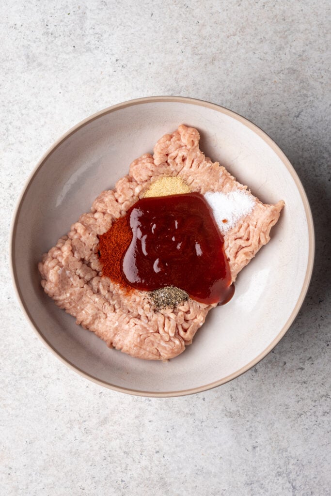 ground chicken in a bowl with bbq sauce and spices