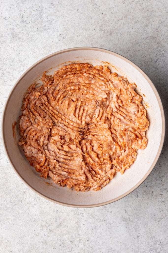 raw ground chicken mixed with bbq sauce and spices