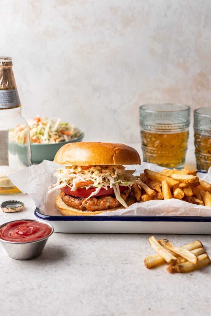 grilled bbq chicken burger with coleslaw and fries