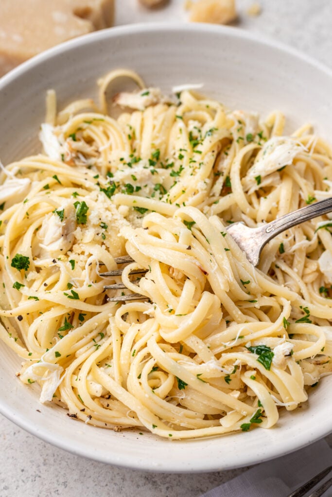 crab pasta in a bowl with a fork