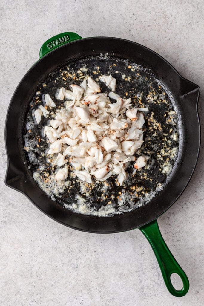 crab meat cooking in a cast iron skillet