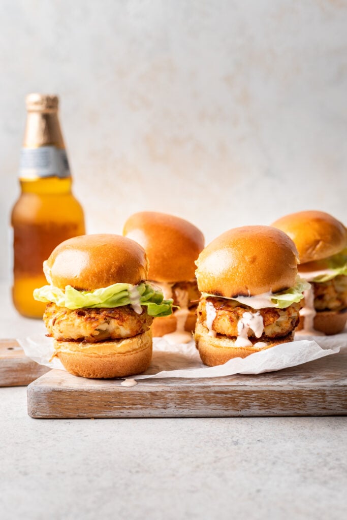 crab cake sliders with lettuce and a beer in the background