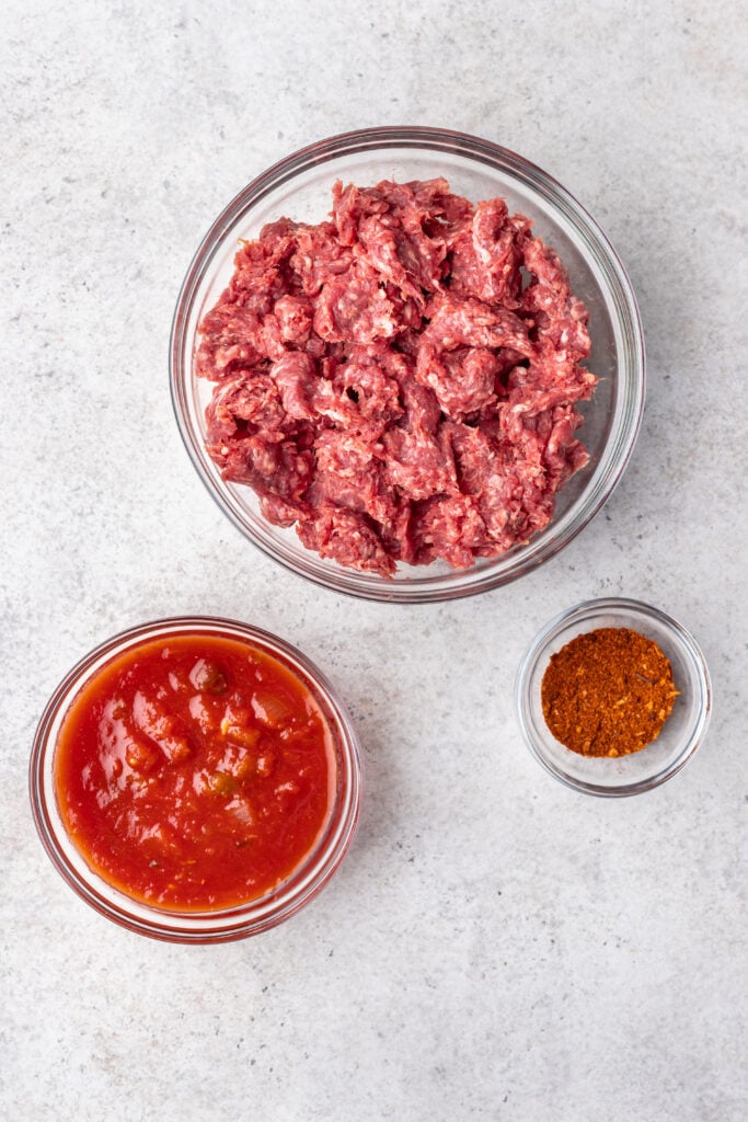3 bowls of ingredients, ground beef, sauce and spices