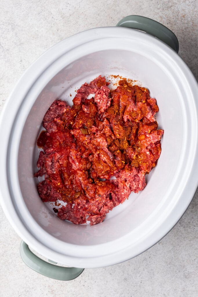 ground meat and spices in a slow cooker