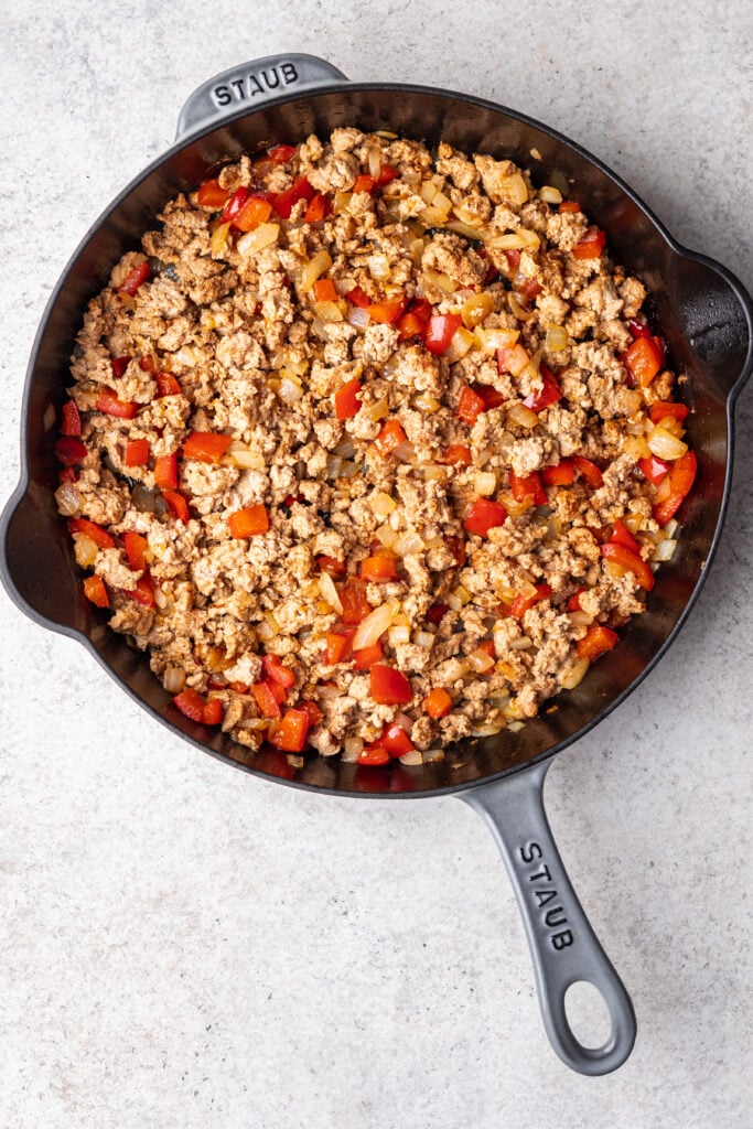 skillet with onions, peppers and ground turkey