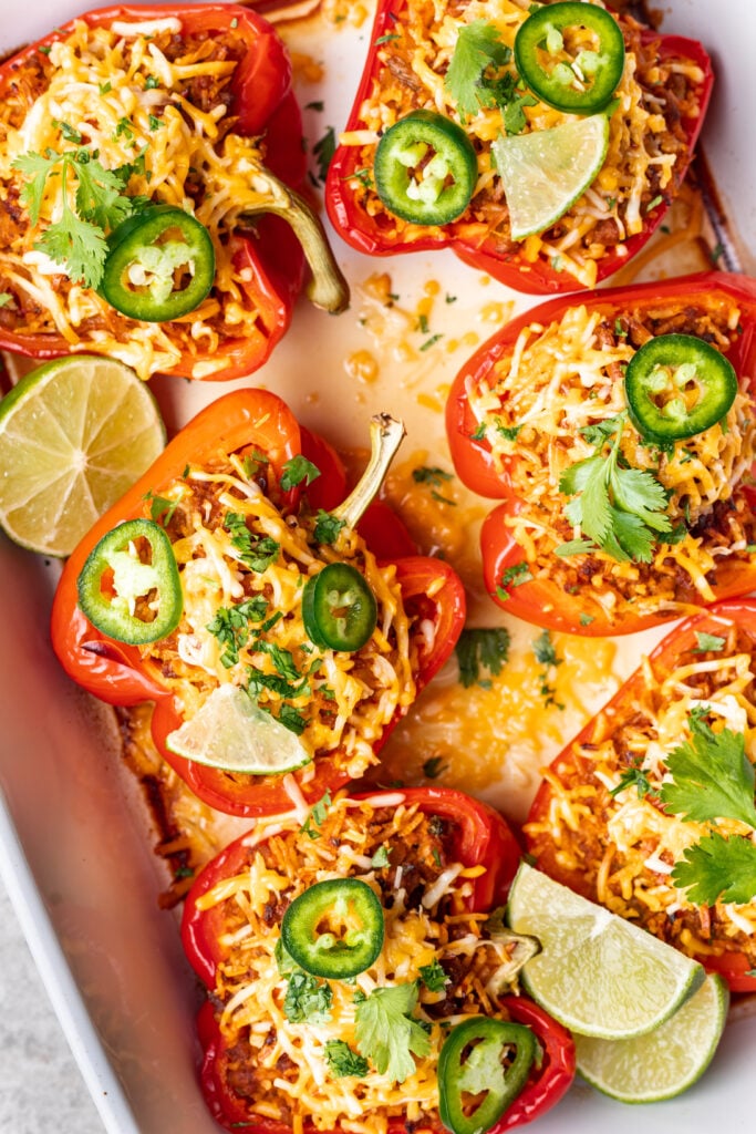 ground turkey stuffed peppers with rice topped with cheese and jalepeno