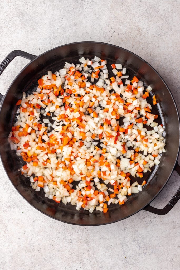 skillet with chopped onion and bell peppers