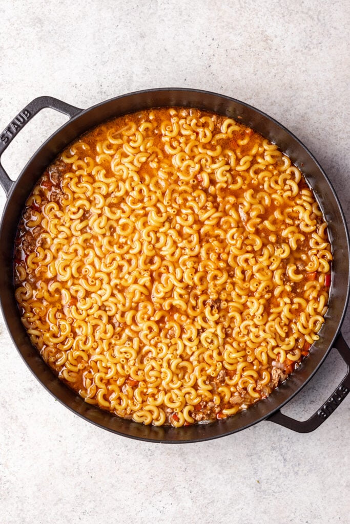 macaroni noodles in a skillet with ground meat