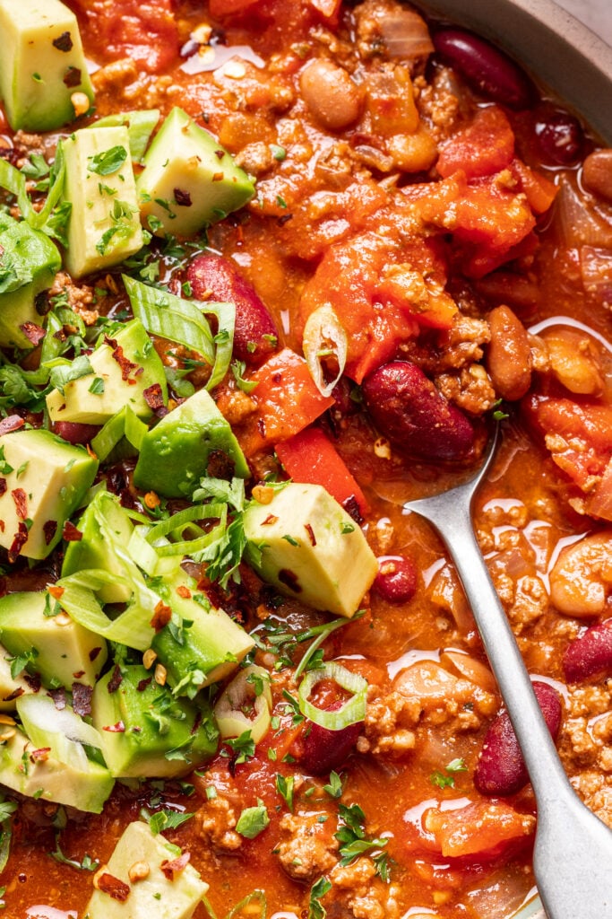 a spoon in a bowl of chili