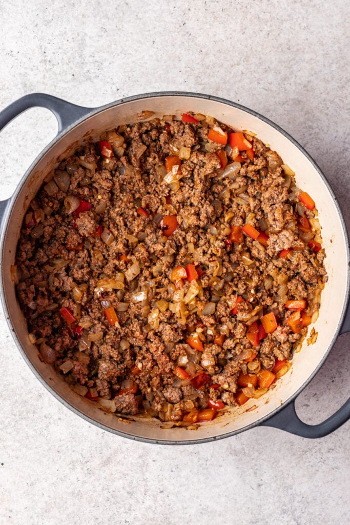 pot with sauteed onions, bell peppers and ground beef