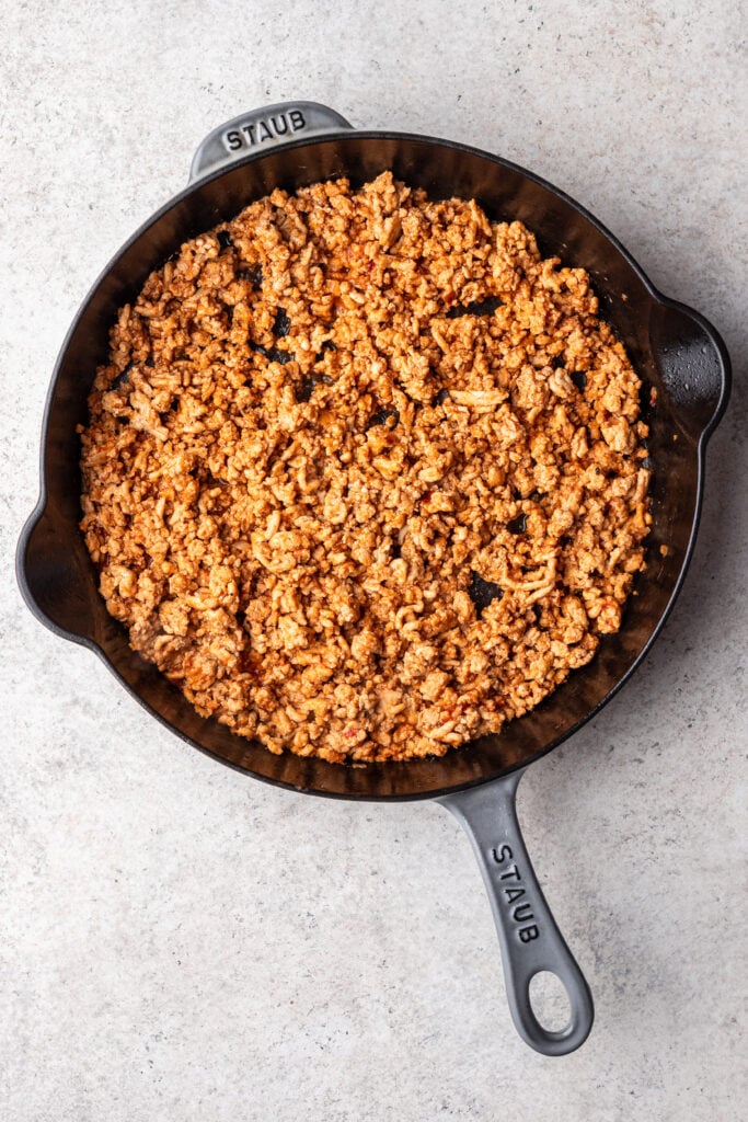 seasoned ground chicken in a cast iron skillet