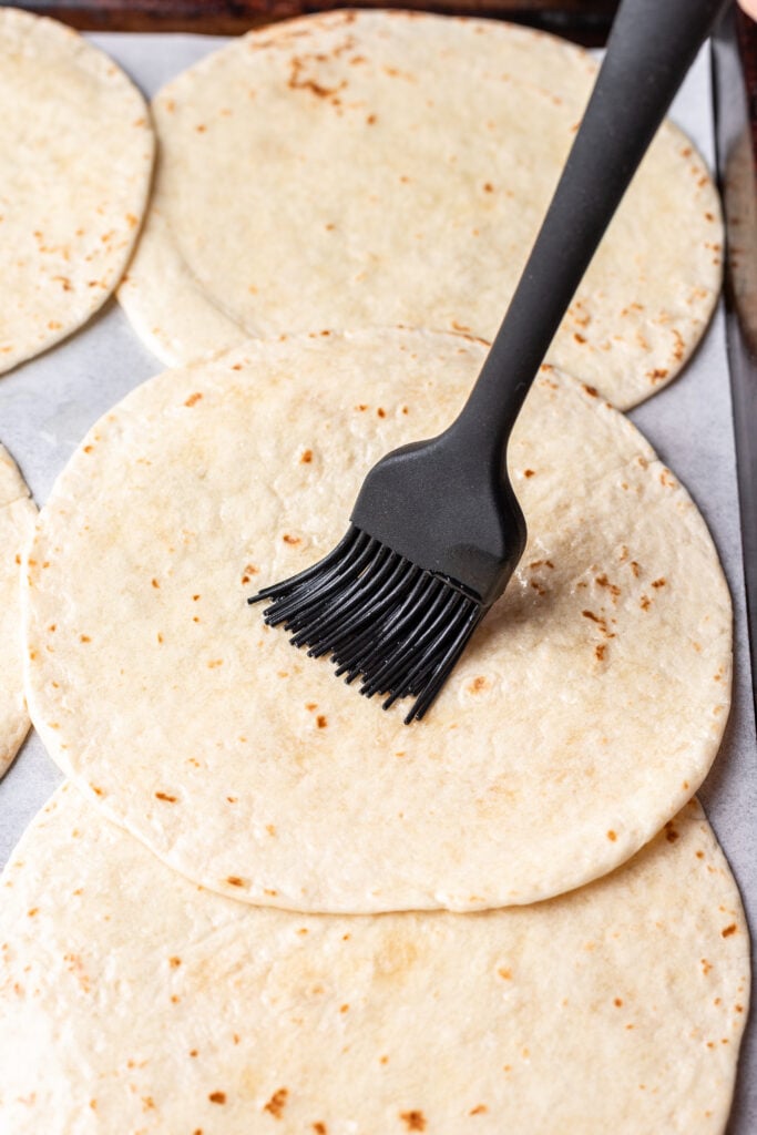 brushing oil on a tortilla